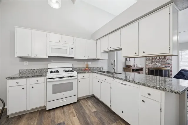 a kitchen with cabinets appliances a sink and a counter top space