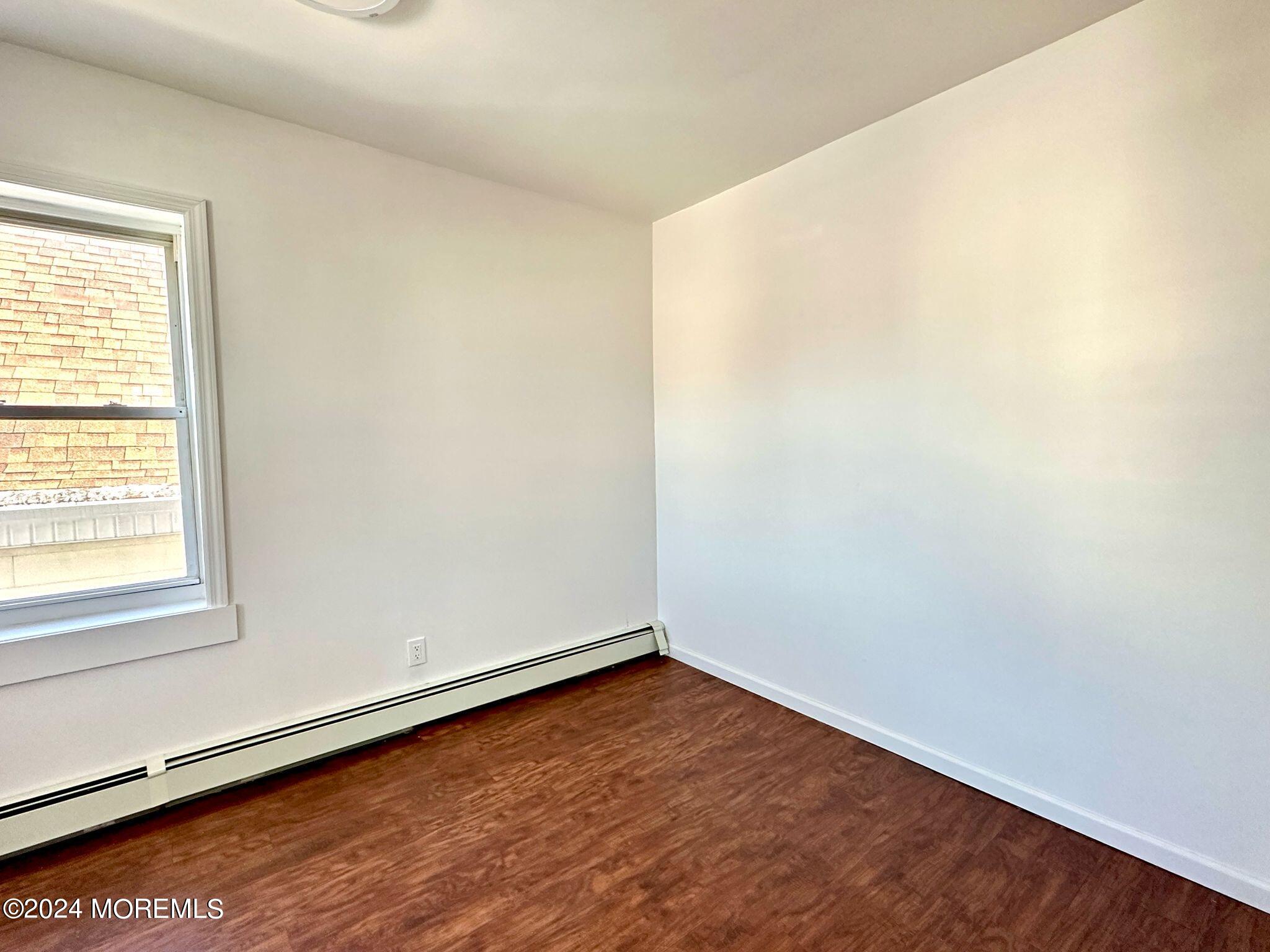 462 Compton Avenue, Unit THIRD Perth Amboy, NJ 08861 - Photo 11 of 14 an empty room with a window