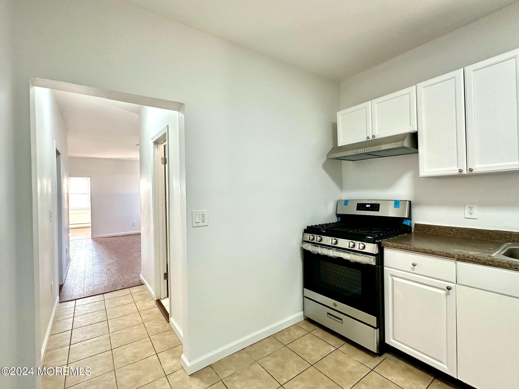 462 Compton Avenue, Unit THIRD Perth Amboy, NJ 08861 - Photo 12 of 14 a kitchen with a stove and a sink
