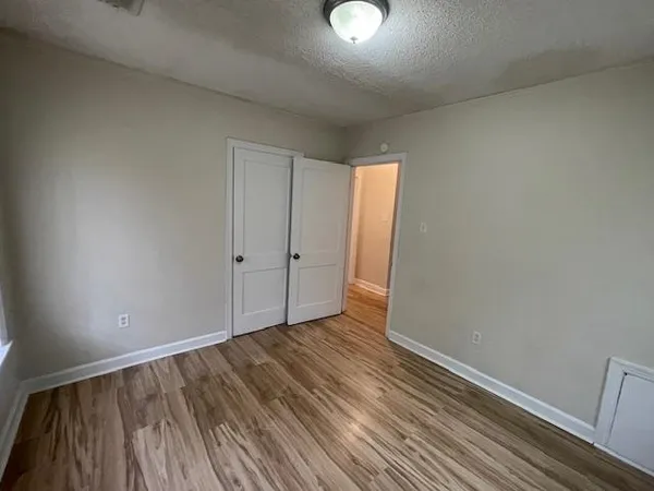 a view of an empty room and wooden floor
