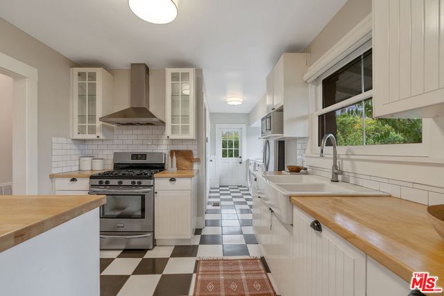 a kitchen with a stove a sink and a refrigerator