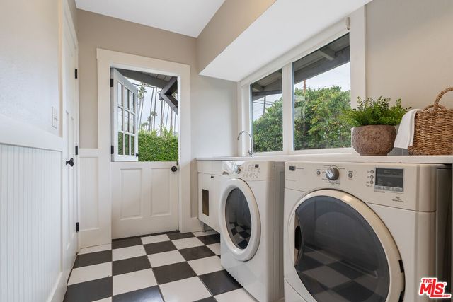 a view of a hallway with washer and dryer