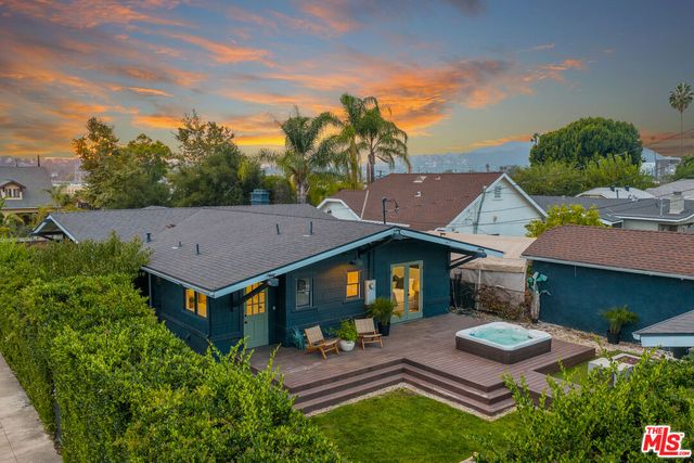 an aerial view of multiple houses with a yard