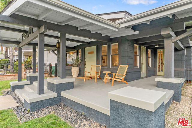a living room with furniture and large windows