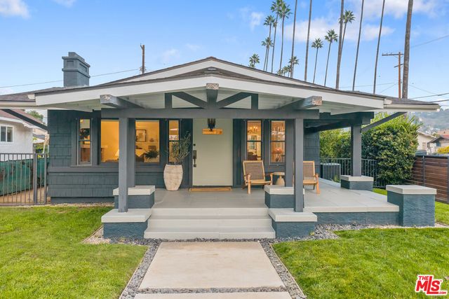 a front view of a house with garden and porch