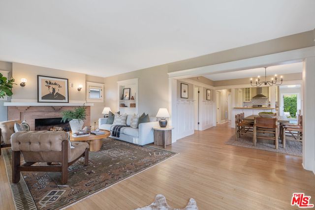 a living room with furniture a fireplace and a table