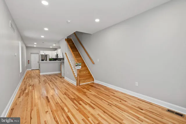 a view of kitchen with wooden floor and electronic appliances