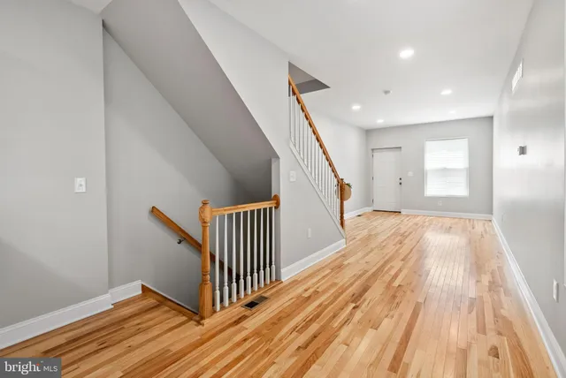 a view of a hallway with wooden floor