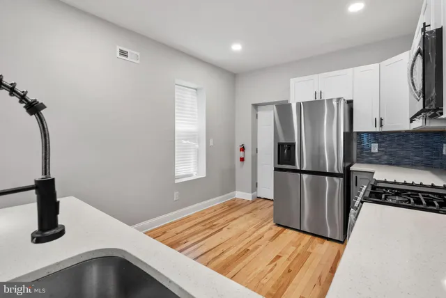 a kitchen with a refrigerator and a sink