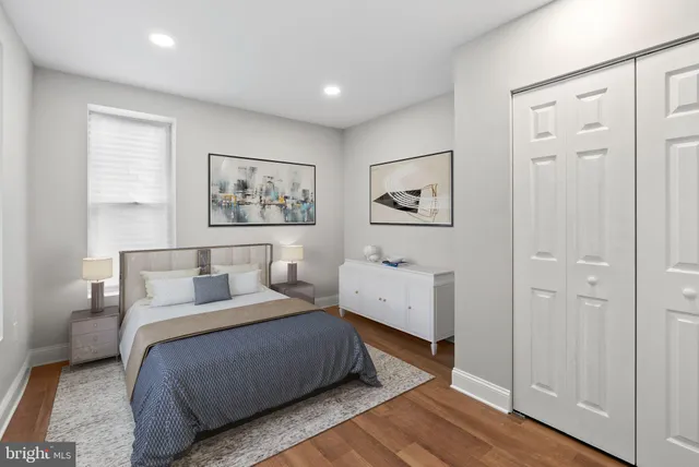 a bedroom with a bed and a painting