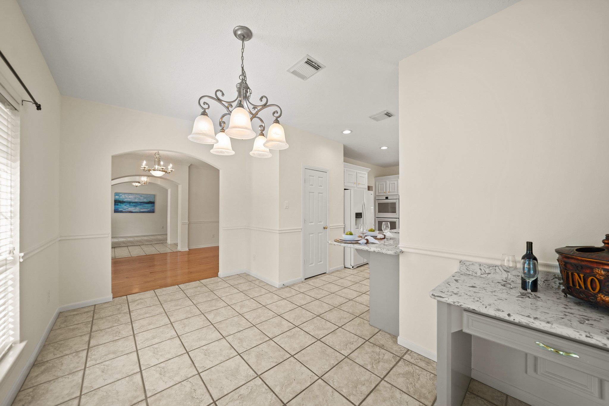 12690 Longmire Way Conroe, TX 77304 - Photo 16 of 50 A view of the formal dining & living rooms in the background with the kitchen conveniently accessible on the right.