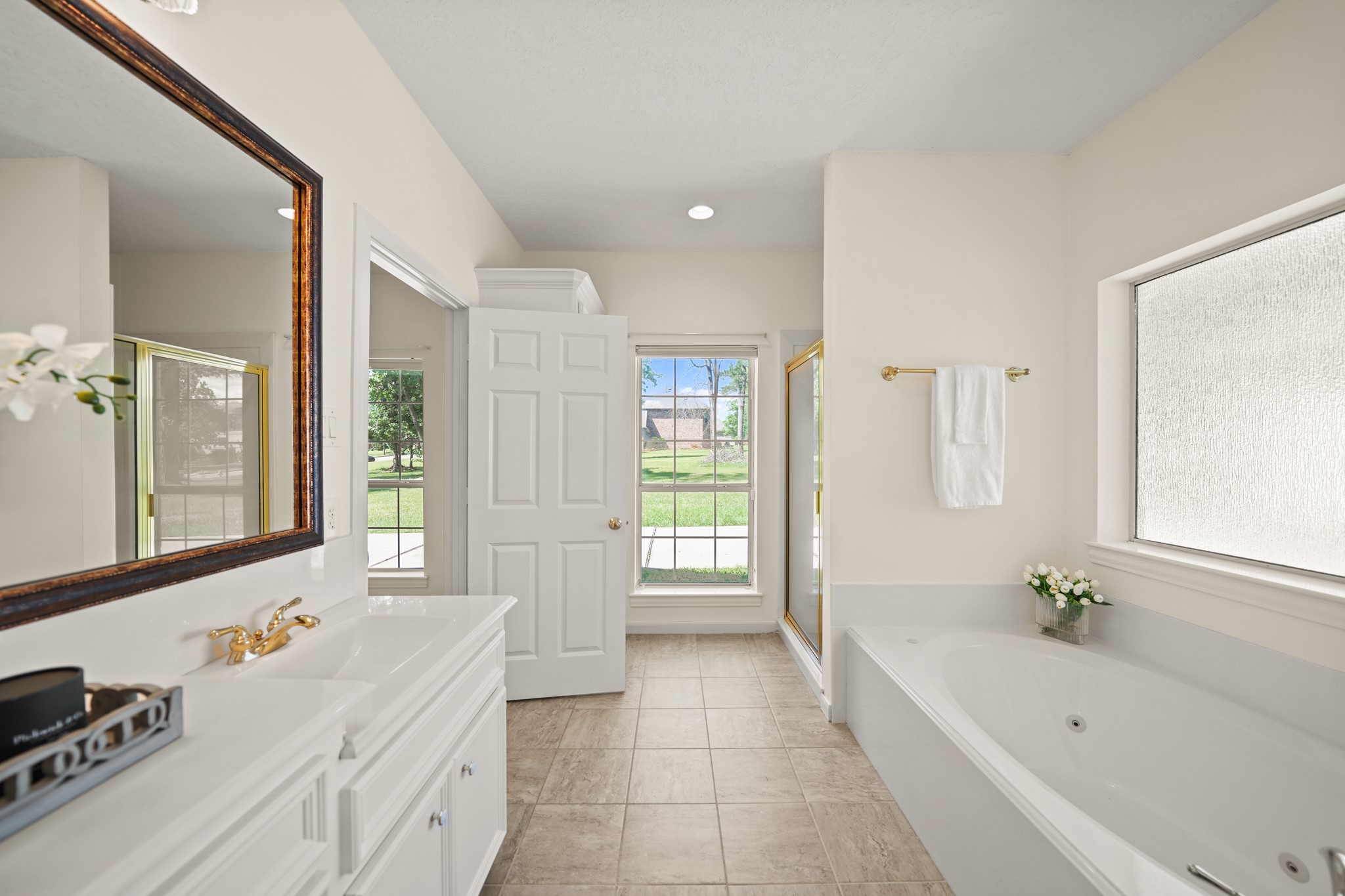 12690 Longmire Way Conroe, TX 77304 - Photo 28 of 50 Additional features include a built-in linen storage closet with clothes hamper, a window with shade overlooking the side yard & updated tile flooring.