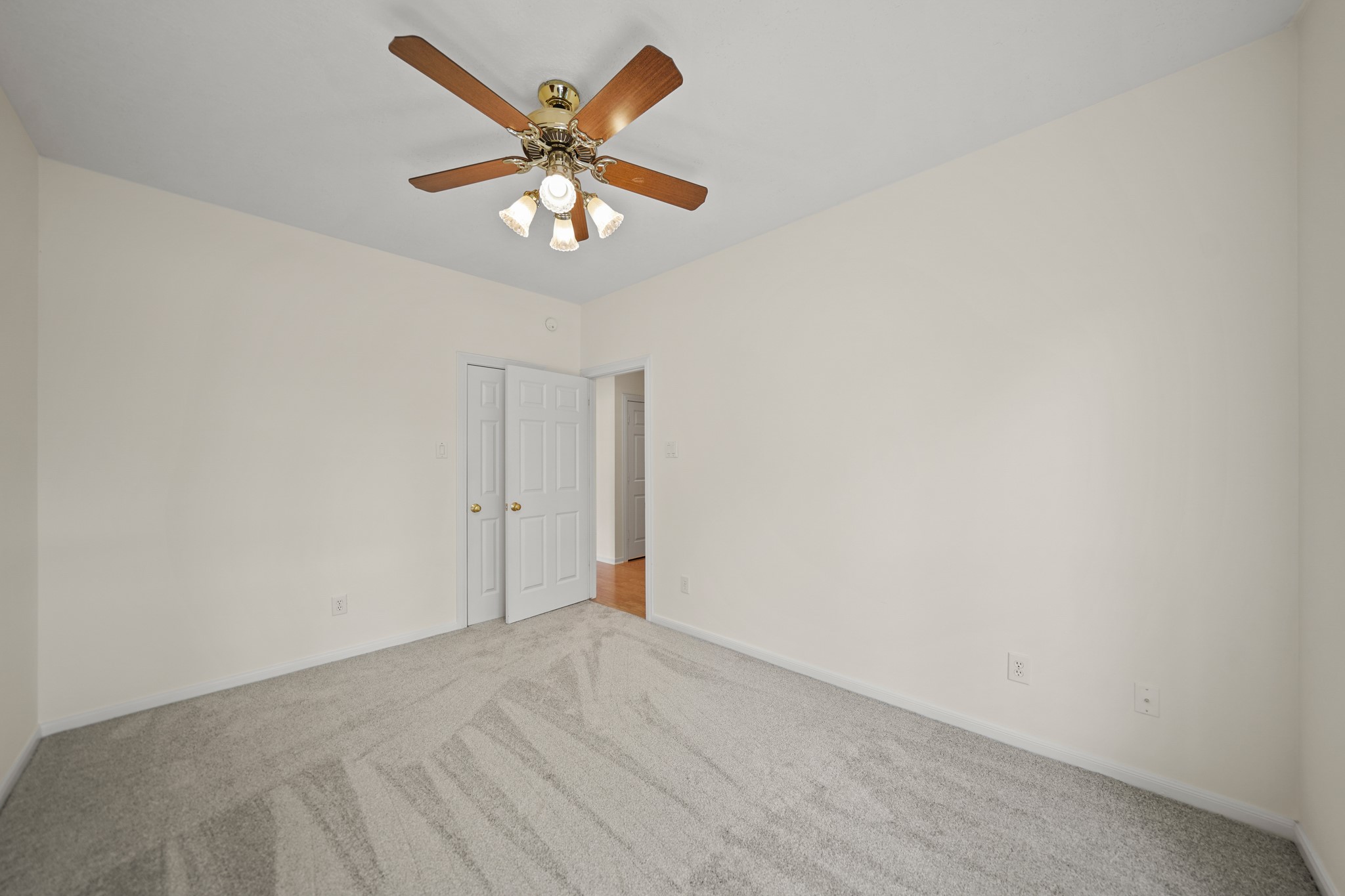 12690 Longmire Way Conroe, TX 77304 - Photo 32 of 50 an empty room with a chandelier fan and a table