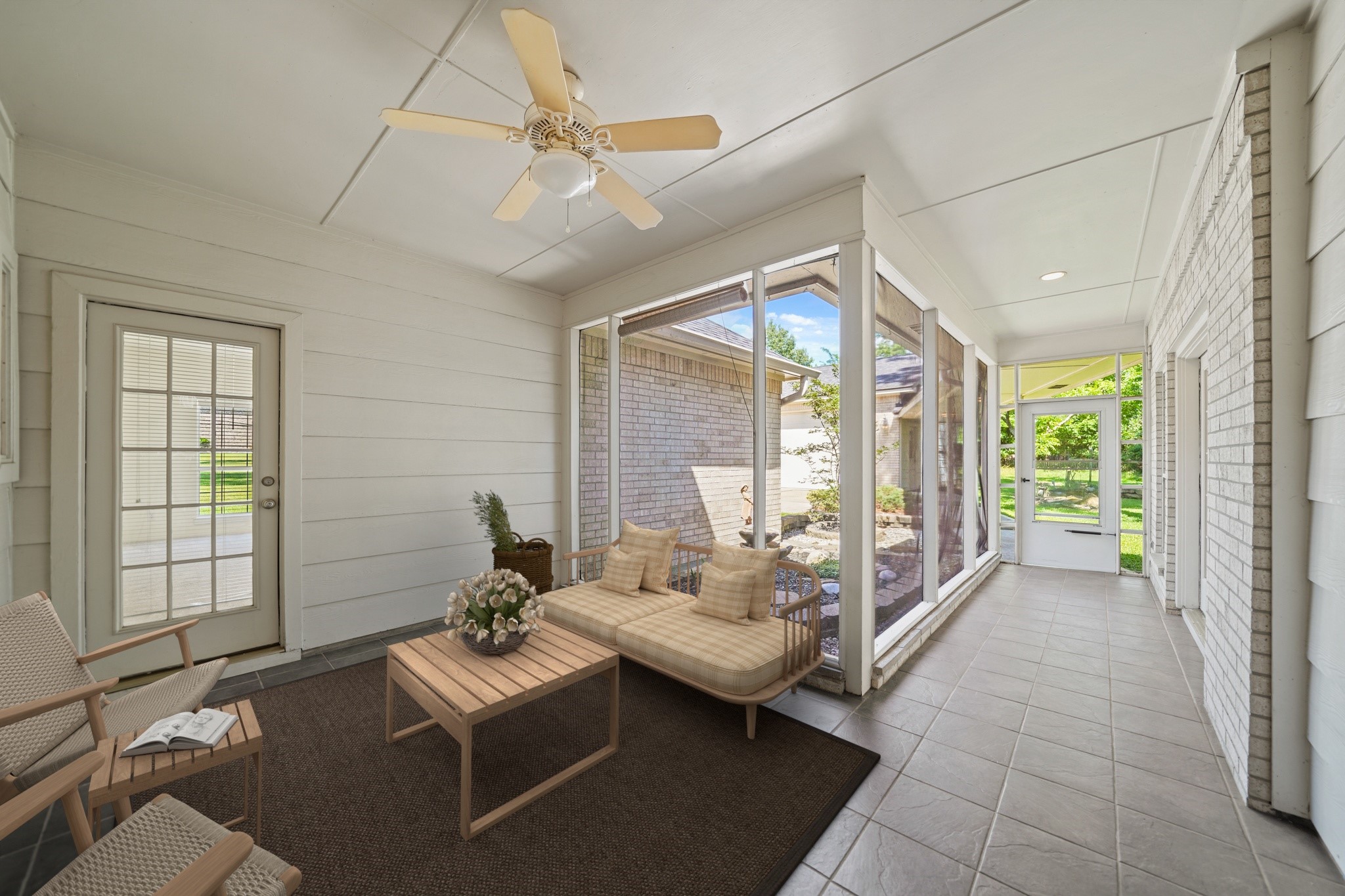 12690 Longmire Way Conroe, TX 77304 - Photo 40 of 50 Perfect for outdoor dining & entertaining is a 26'x 14' screened patio accessible from the family room, primary bedroom suite & bonus room. This photo has been virtually staged.