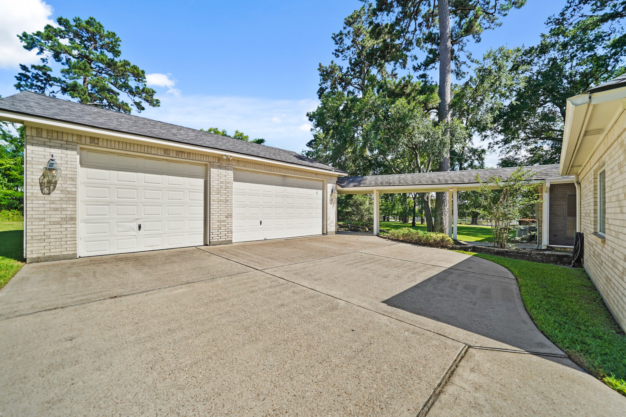 12690 Longmire Way Conroe, TX 77304 - Photo 47 of 50 front view of a house with a yard and potted plants