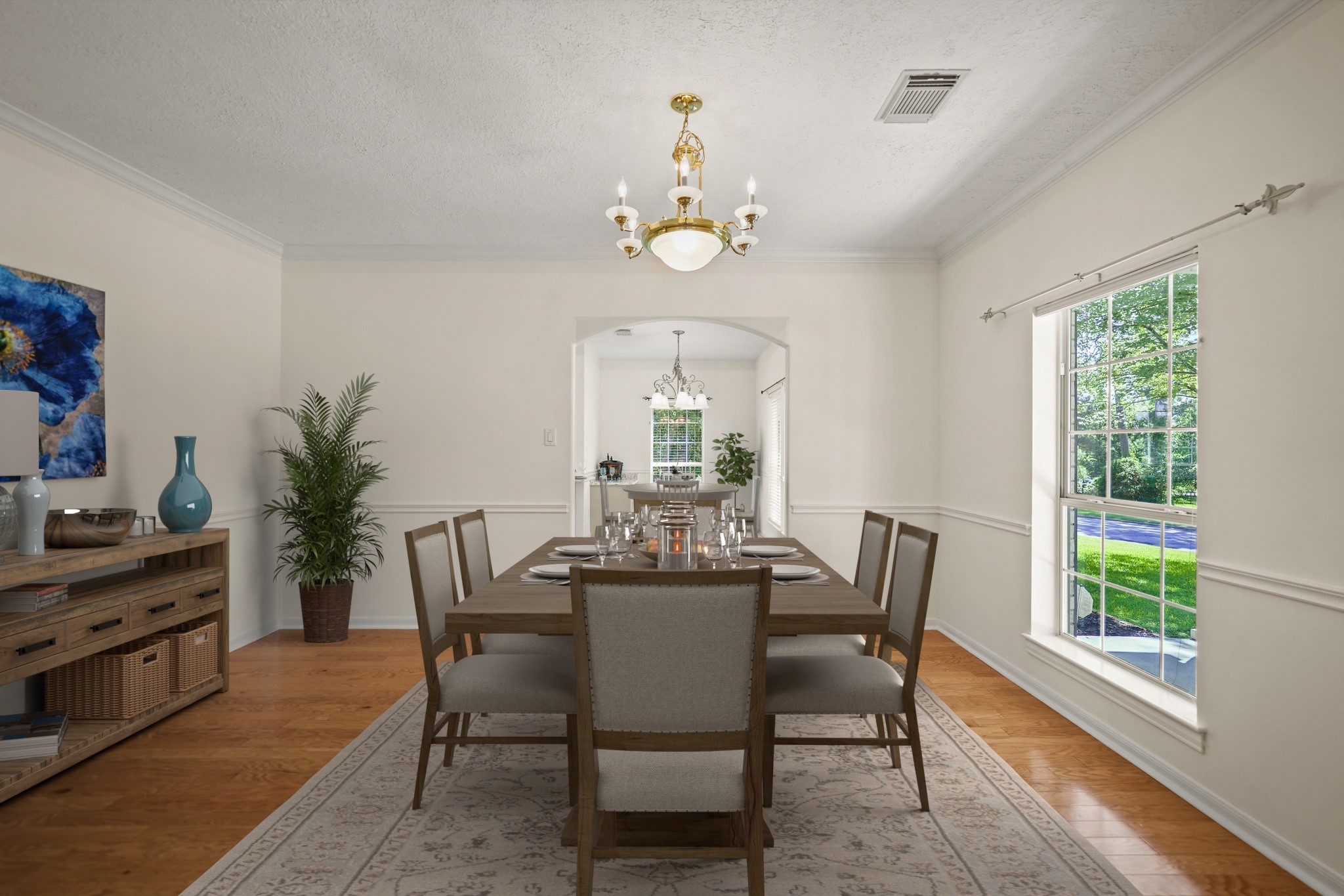 12690 Longmire Way Conroe, TX 77304 - Photo 6 of 50 a dining room with wooden floor a chandelier a wooden table and chairs