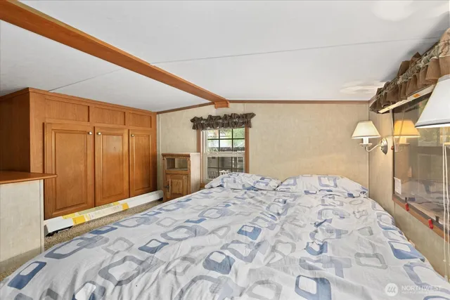 a bedroom with a bed and a large window