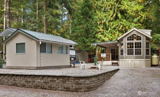 a view of a house with a yard and sitting area