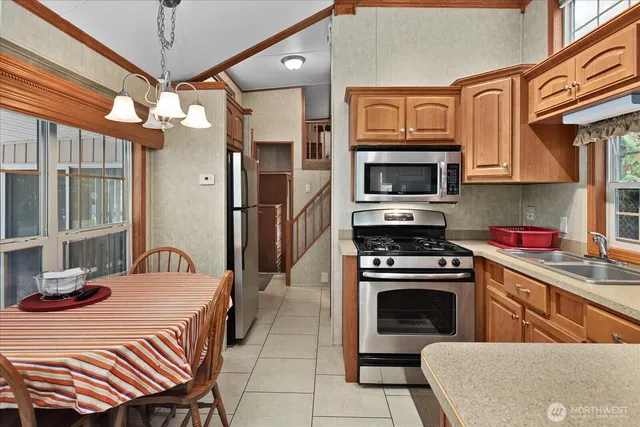 a kitchen with a stove a sink and a microwave