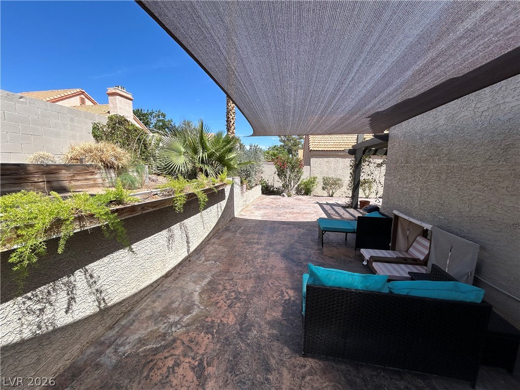 267 Westwind Road Henderson, NV 89074 - Photo 24 of 27 A private outdoor space with a shaded patio and tiered landscaping.