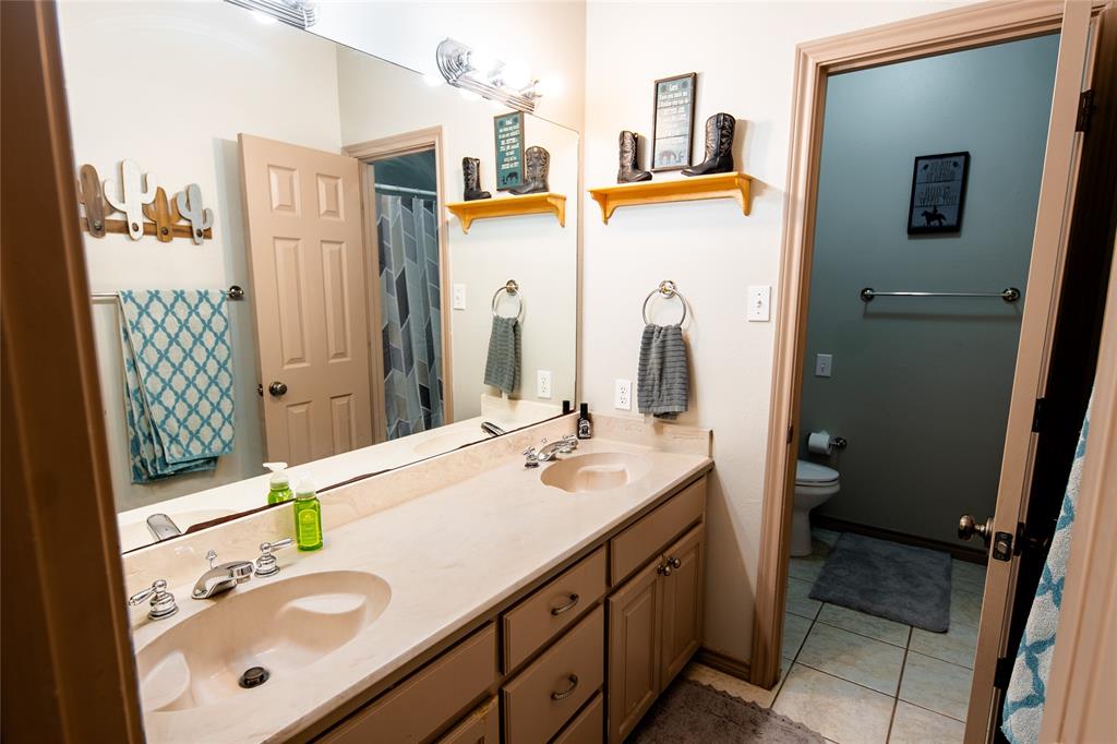 2211 Mc Alpin Road Midlothian, TX 76065 - Photo 17 of 37 a bathroom with a sink vanity granite and a mirror