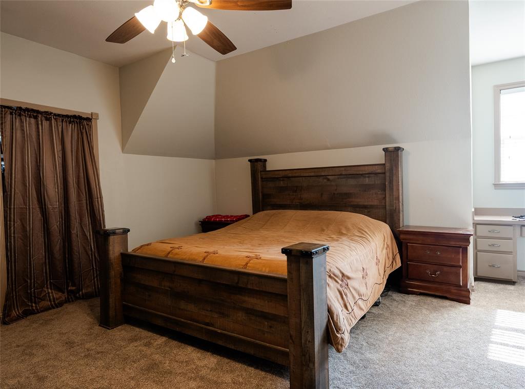 2211 Mc Alpin Road Midlothian, TX 76065 - Photo 21 of 37 a bed sitting in a bedroom next to a window