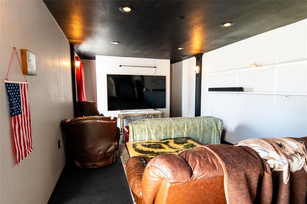 2211 Mc Alpin Road Midlothian, TX 76065 - Photo 23 of 37 a living room with a bed furniture and a flat screen tv