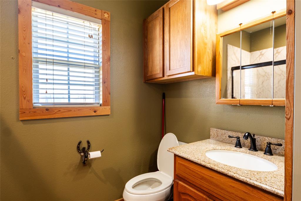 2211 Mc Alpin Road Midlothian, TX 76065 - Photo 31 of 37 a bathroom with a granite countertop toilet sink and mirror