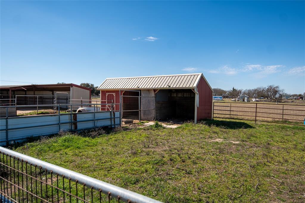 2211 Mc Alpin Road Midlothian, TX 76065 - Photo 37 of 37 a view of a house with a backyard and a chair