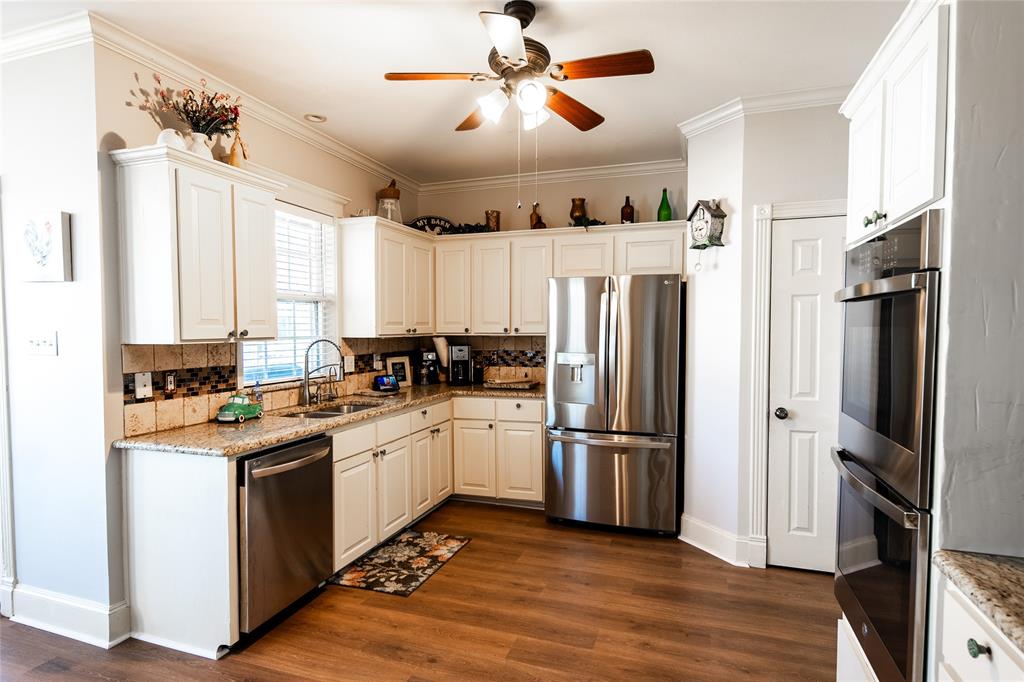 2211 Mc Alpin Road Midlothian, TX 76065 - Photo 4 of 37 a kitchen with stainless steel appliances a refrigerator sink and microwave
