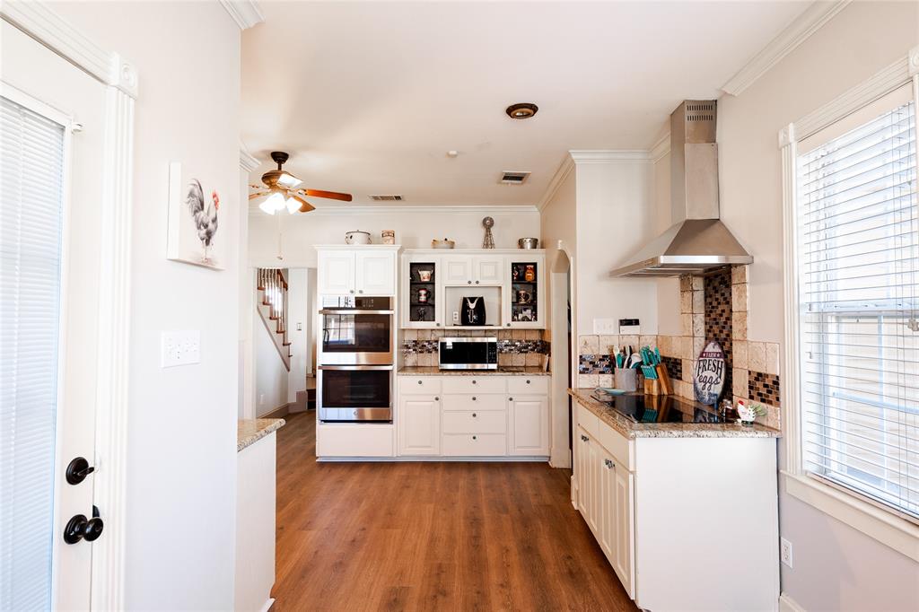 2211 Mc Alpin Road Midlothian, TX 76065 - Photo 5 of 37 a kitchen with stainless steel appliances a stove top oven a sink a chimney and a refrigerator