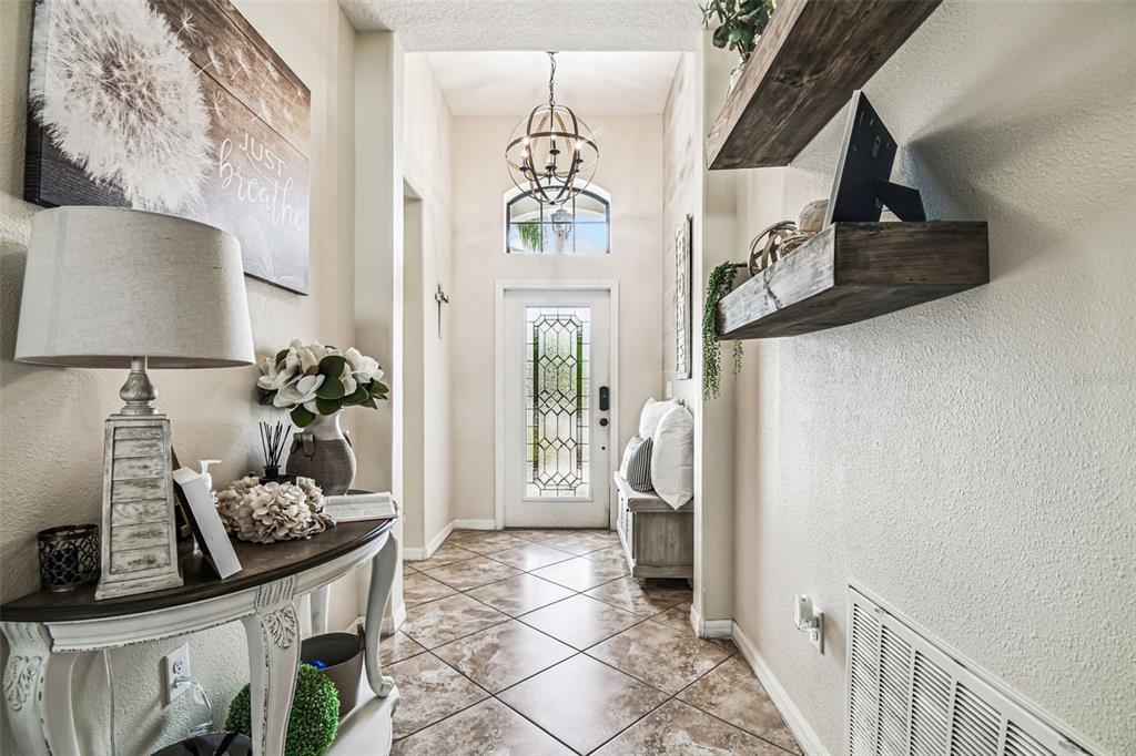 13807 Felix Will Road Riverview, FL 33579 - Photo 11 of 91 a view of a hallway to a livingroom with furniture
