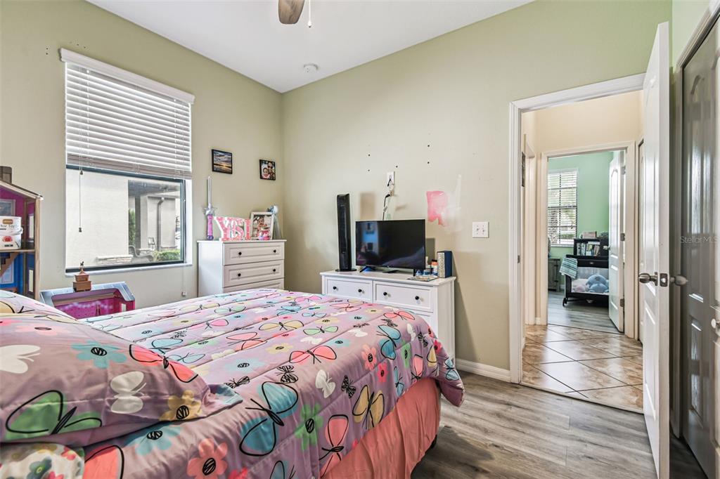 13807 Felix Will Road Riverview, FL 33579 - Photo 16 of 91 a bedroom with a bed and a television