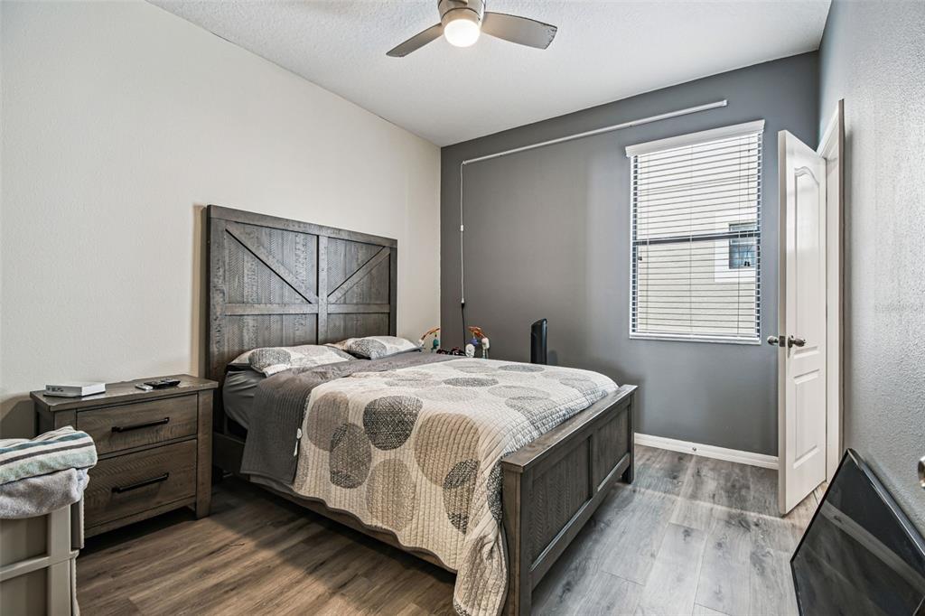 13807 Felix Will Road Riverview, FL 33579 - Photo 35 of 91 a bedroom with a bed and a ceiling fan