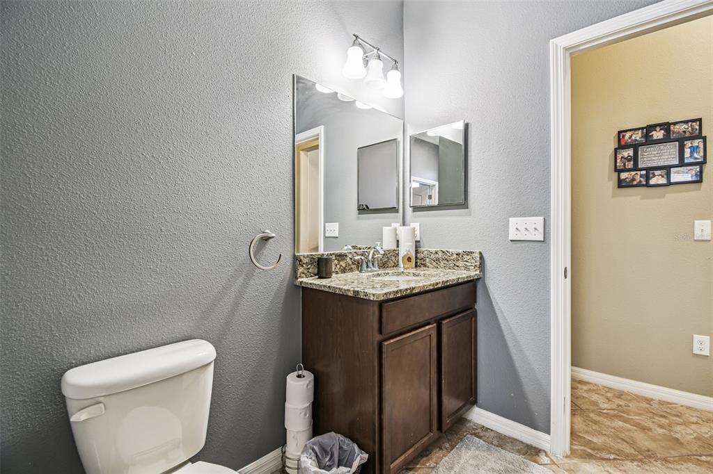 13807 Felix Will Road Riverview, FL 33579 - Photo 39 of 91 a bathroom with a toilet sink and mirror