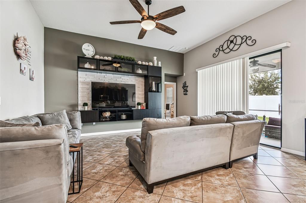 13807 Felix Will Road Riverview, FL 33579 - Photo 49 of 91 a living room with furniture and a flat screen tv