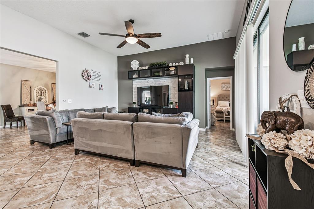 13807 Felix Will Road Riverview, FL 33579 - Photo 50 of 91 a living room with furniture and a fireplace