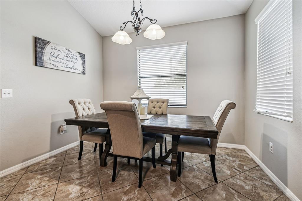 13807 Felix Will Road Riverview, FL 33579 - Photo 54 of 91 a view of a dining room with furniture window and wooden floor