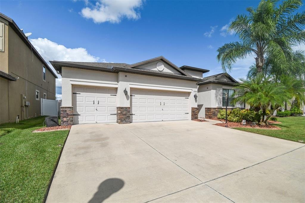 13807 Felix Will Road Riverview, FL 33579 - Photo 7 of 91 a front view of a house with a yard and garage