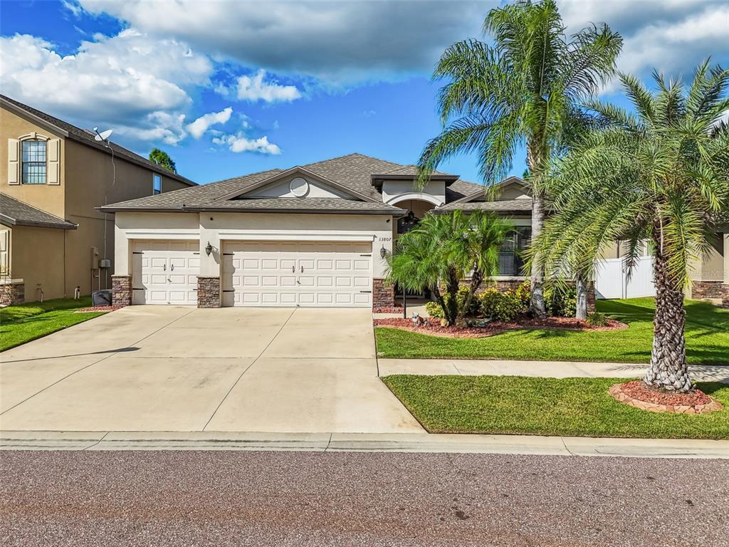13807 Felix Will Road Riverview, FL 33579 - Photo 76 of 91 a front view of a house with a yard and garage