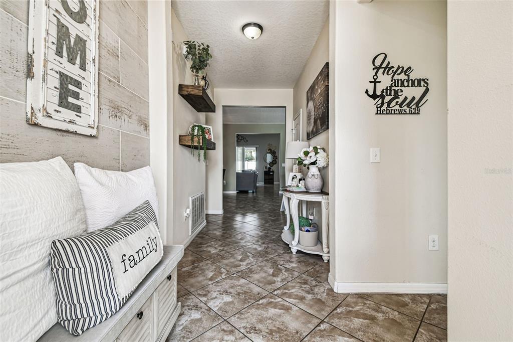 13807 Felix Will Road Riverview, FL 33579 - Photo 10 of 91 a view of a hallway to a livingroom with furniture and windows