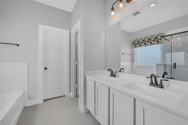 a bathroom with a double vanity sink mirror and