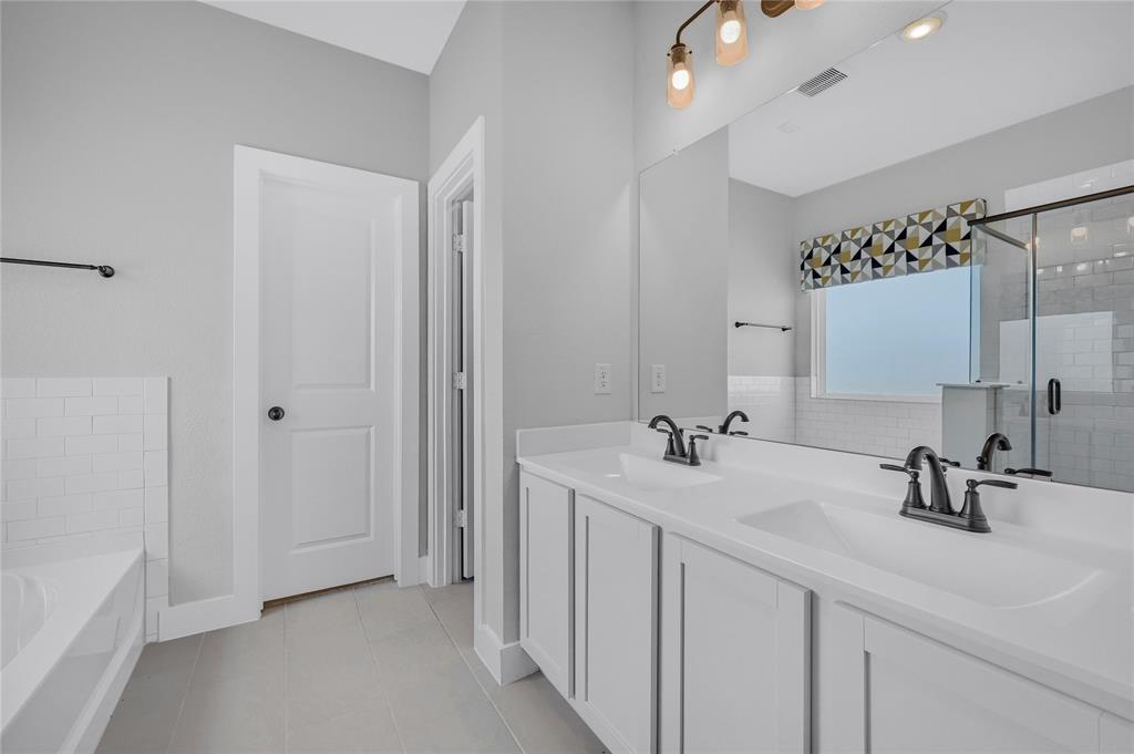1902 Aleia Cove Sherman, TX 75092 - Photo 12 of 25 a bathroom with a double vanity sink mirror and