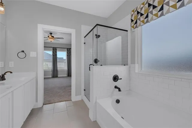 a bathroom with a bathtub and shower