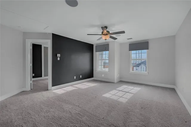 a view of a livingroom with a ceiling fan and window