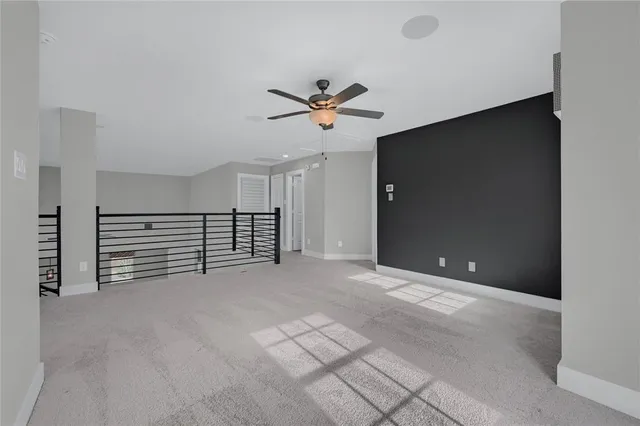 a view of an empty room with a ceiling fan