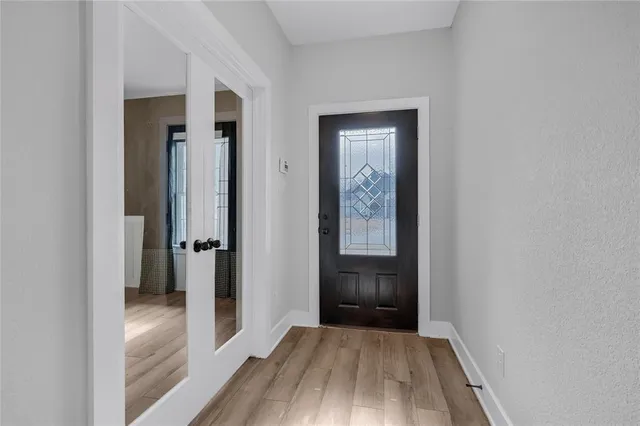 a view of a hallway with wooden floor
