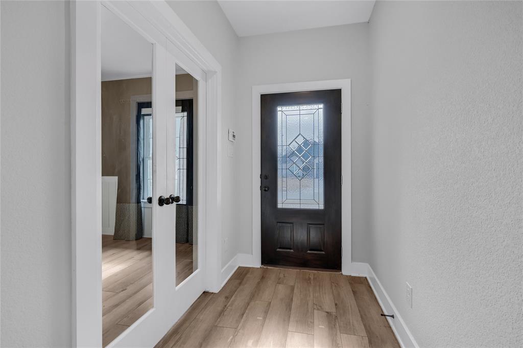 1902 Aleia Cove Sherman, TX 75092 - Photo 3 of 25 a view of a hallway with wooden floor