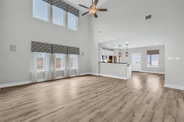 a view of a kitchen with wooden floor and a sink