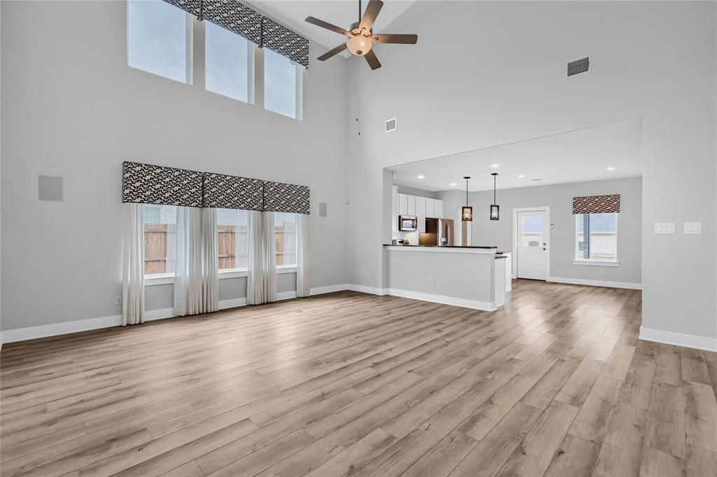 1902 Aleia Cove Sherman, TX 75092 - Photo 6 of 25 a view of a kitchen with wooden floor and a sink